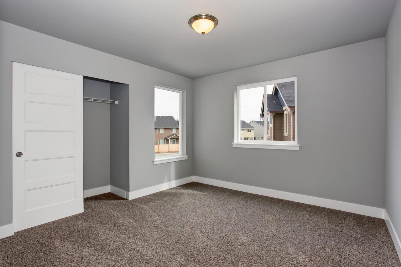 Small basement room interior with grey walls and white trim.